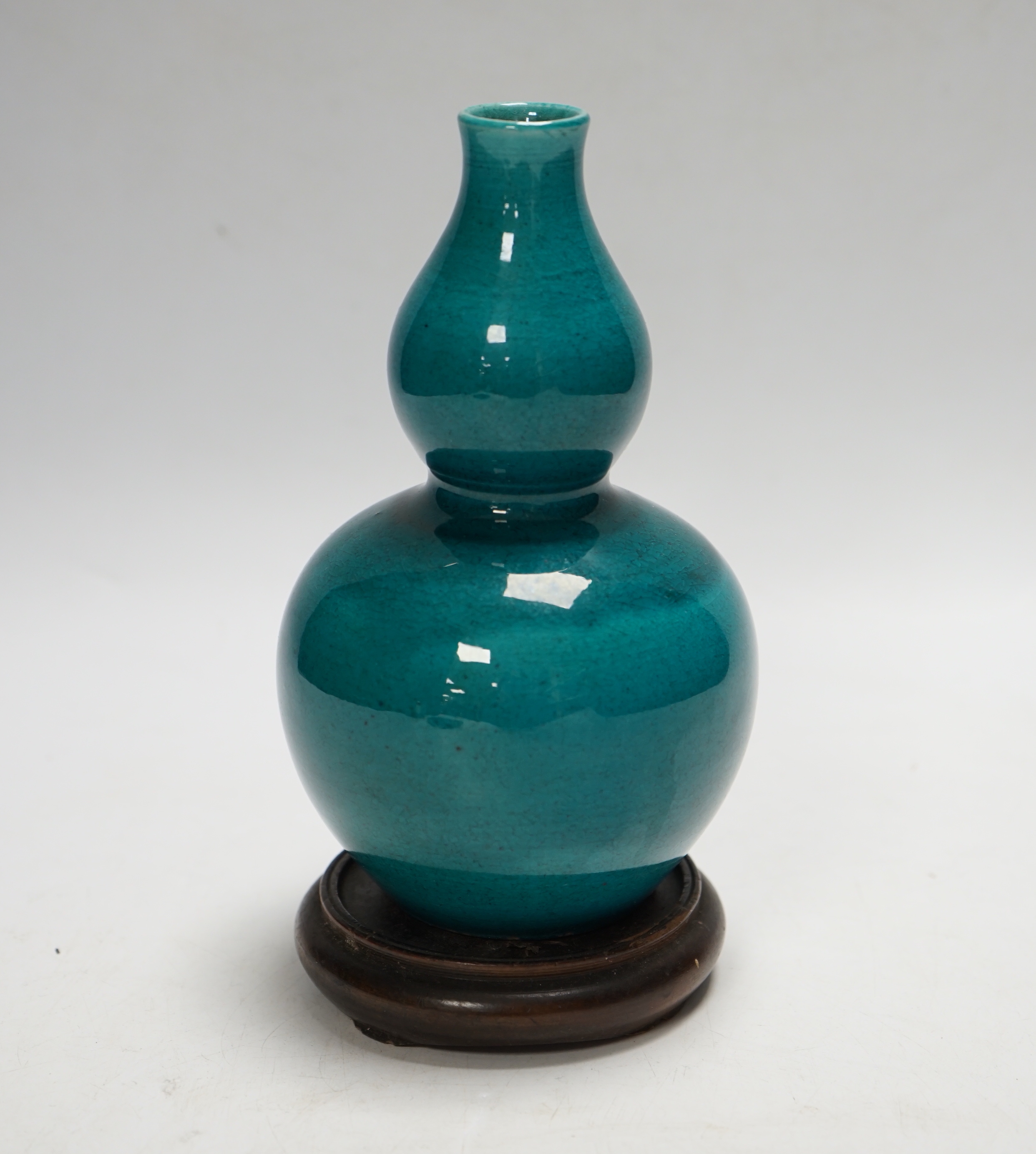 A Chinese turquoise glazed double gourd vase, on stand, 17cm